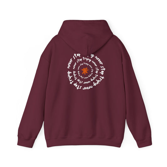 "FIBRIO Never Stop Trying hoodie back in maroon – unisex casual hoodie with long-lasting screen print design and comfortable laid-back fit."