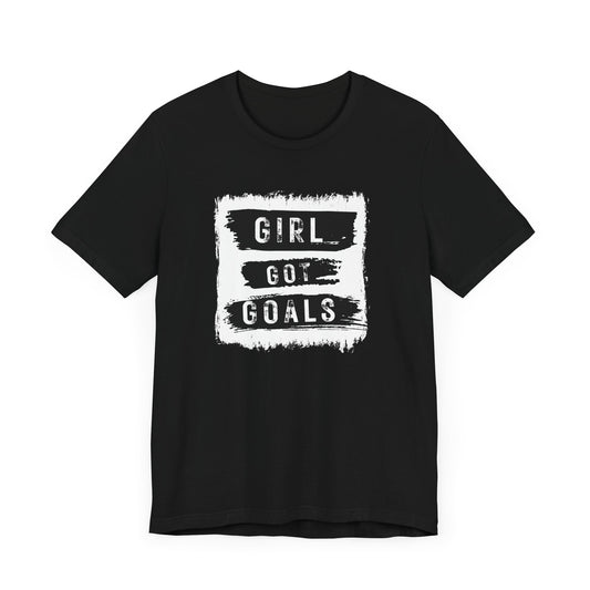 Black women’s Girl Got Goals t-shirt with black-and-white brushstroke motivational graphic on front – inspirational streetwear tee by FIBRIO