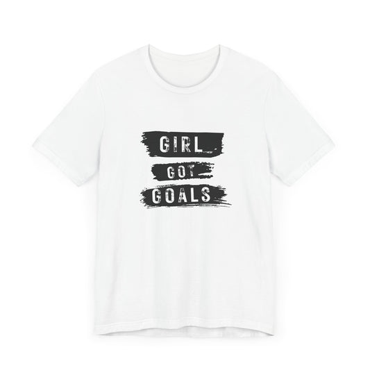 White women’s Girl Got Goals t-shirt with black-and-white brushstroke motivational graphic on front – inspirational streetwear tee by FIBRIO